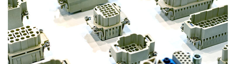 a collection of gray connectors attached on a white surface