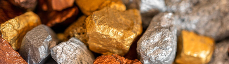 close up of an assortment of metal nuggets in colors of copper, gold, and silver