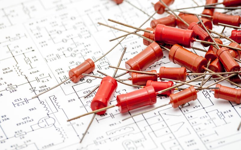 passive capacitors on top of a blueprint schematic