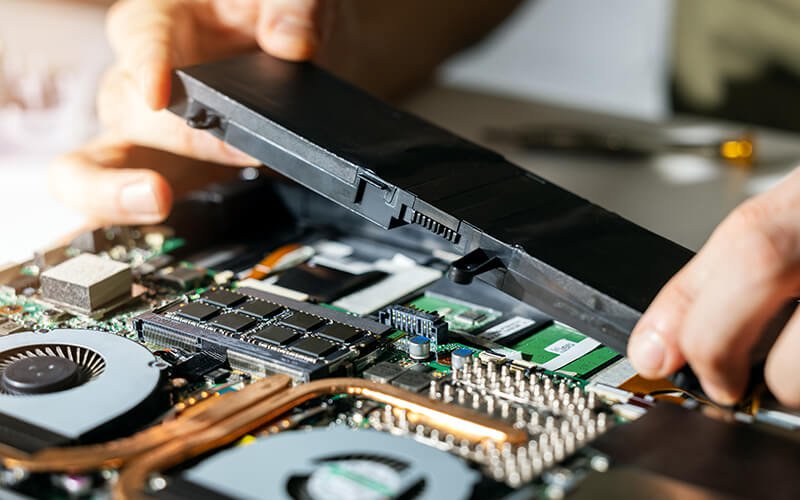hands working on a circuit board