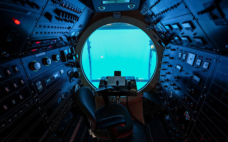 Picture from inside an underwater submarine with buttons, levers, and meters